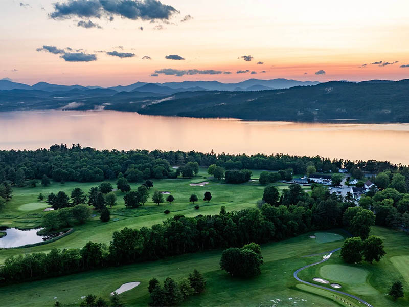 The Golf Club at Basin Harbor aerial view at sunrise with Lake Champlain